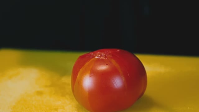 Cutting Knife Of A Large Red Tomato