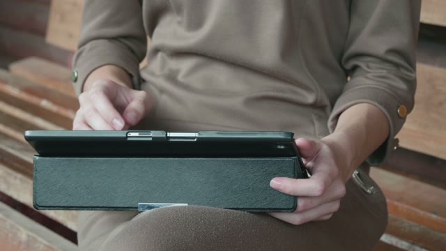 Girl Sits With A Tablet Close-up