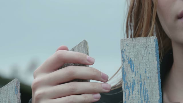 Girl Standing Near The Fence Close-up
