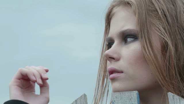 Girl Standing Near The Fence Close-up