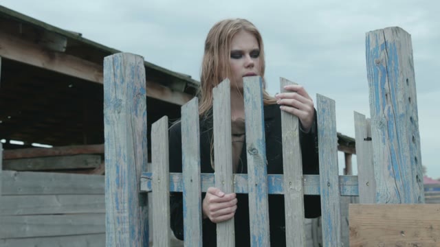Girl Standing Near The Fence