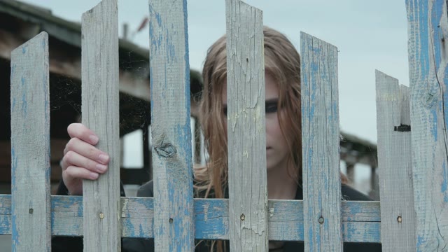 Girl Standing Near The Fence Close-up
