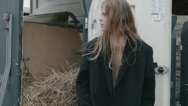 Girl Standing Near Hay Close-up