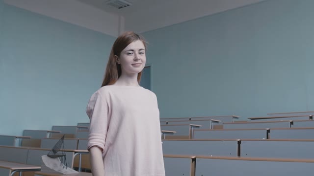 The Girl Student In A Pink Blouse In The Classroom