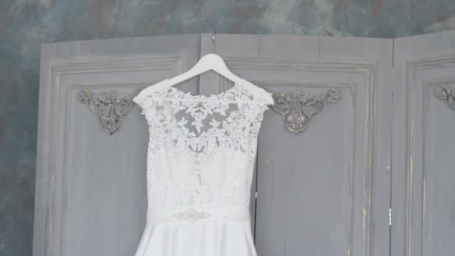 Wedding Dress Hangs On Hangers Close-up