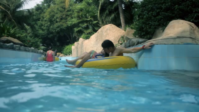 Girl And Guy Swimming In The Pool