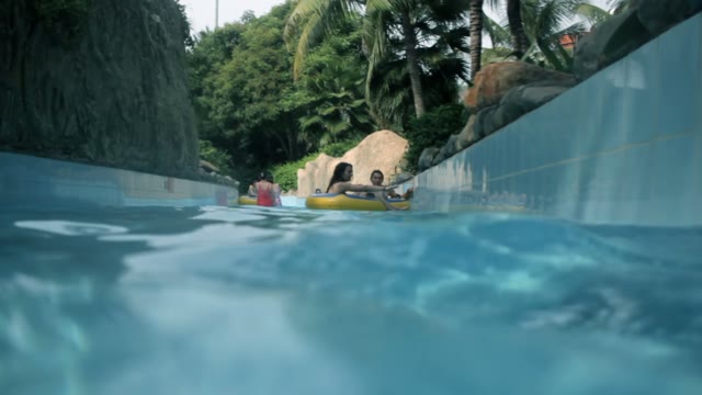Girl And Guy Swimming In The Pool
