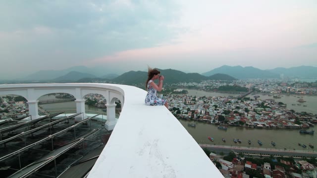 Girl Sitting On A Background Of Mountains And Sea