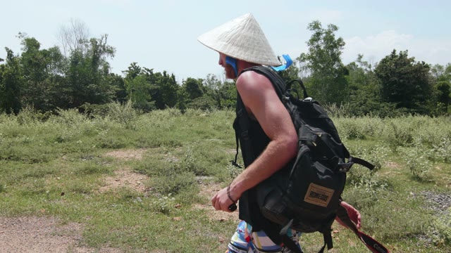 Man Goes Among The Bushes Close-up