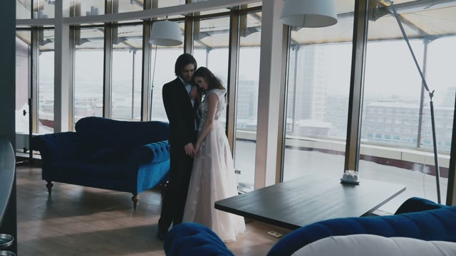Bridal Couple Standing Arm In Arm In A Beautiful Building
