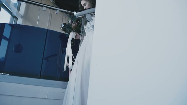 The Girl In A Wedding Dress Going Down The Stairs