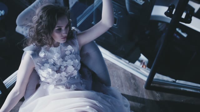 Beautiful Bride In Wedding Dress Sitting In A Chair