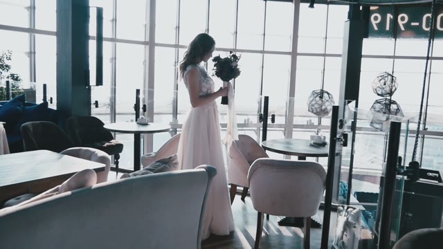 The Bride With A Bouquet In Hands Standing In The Chic Interior