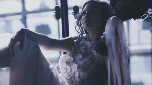 Beautiful Bride With Bouquet In Hands Sitting On The Floor