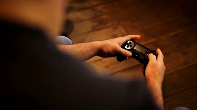 The Man Plays With A Joystick Console
