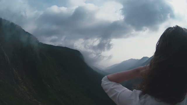 Woman Standing At The Cliff Of Mount Close-up