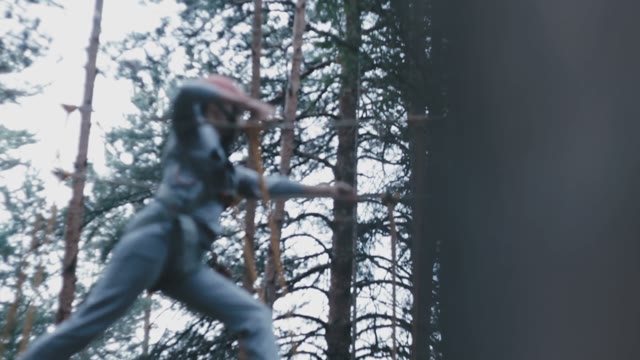 Woman Wearing A Helmet Hanging Overcomes Obstacles