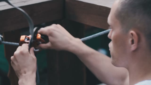 The Instructor Explains The Girl Rope-walker How To Hook Fastening