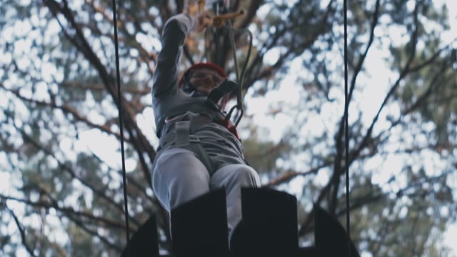 The Girl In A Helmet Learns To Walk On A Tightrope With Obstacles