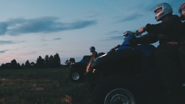 A Team Of Guys On Quads Went In The Evening In The Forest