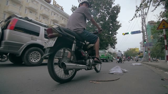 Skateboarder Passes A Man On A Moped