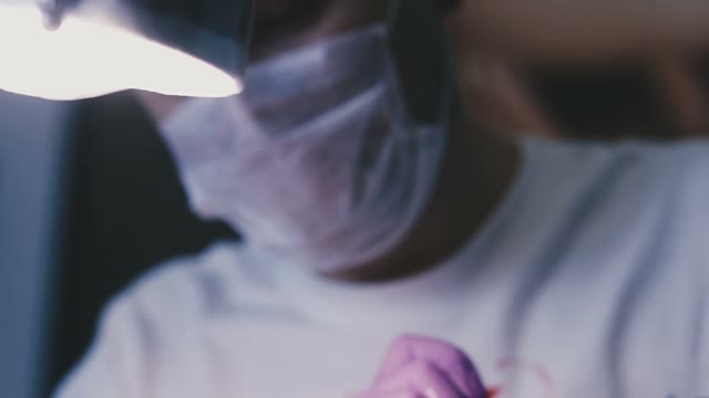 Young Short-cut Tattoo Artist At Work