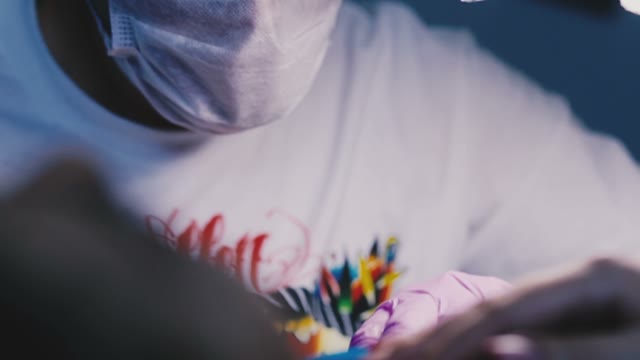 Young Beautiful Tattoo Artist Draws A Tattoo