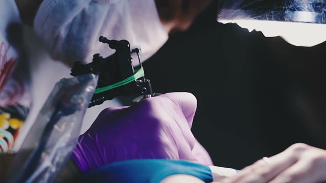 Tattoo Artist Draws A Tattoo