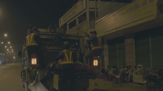 Workers Are Moving On A Garbage Truck