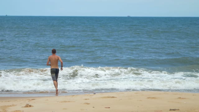 Man Runs To Swim In The Ocean During A Storm