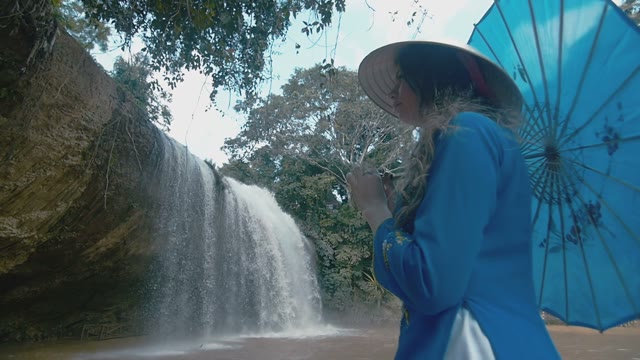 Girl On The Background Of A Small Waterfall
