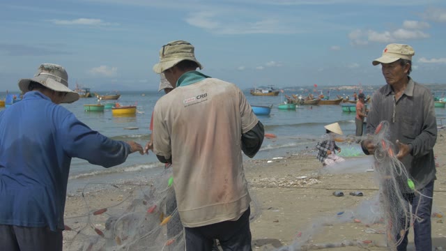 Men In Hats Fold The Fishing Net