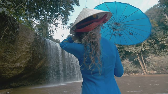Girl On The Background Of A Small Waterfall