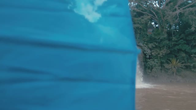 Girl On The Background Of A Small Waterfall Close-up
