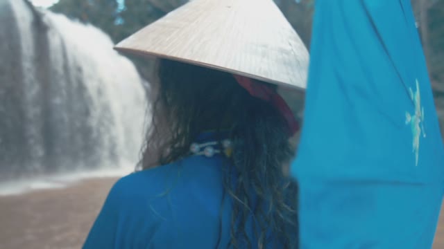 Girl On The Background Of A Small Waterfall Close-up