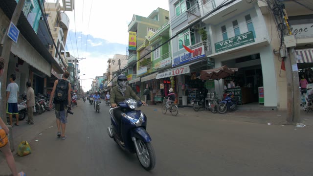 A Small Road With Motorcycles Passing Among The Houses