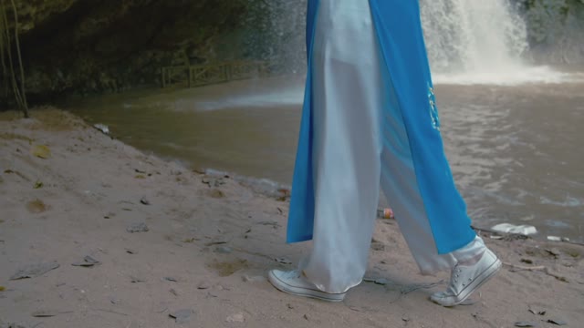 Girl's Legs Against The Waterfall Background
