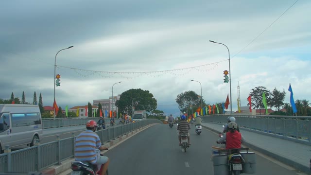 The Road On The Bridge Full Of Of Motorcyclists And Flags