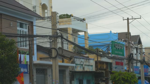 Houses And Shops With Signboards Beside The Road