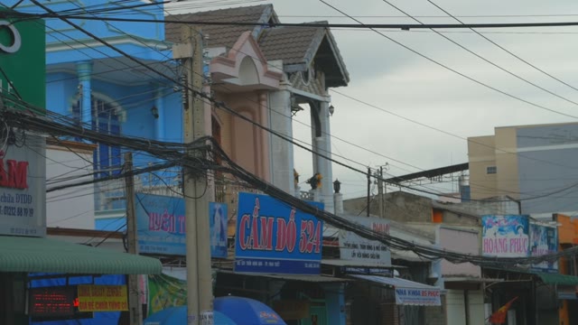 A View Of The Balconies Houses And The Shop Signs And Long Wires