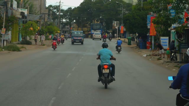 Motorcyclist Goes To The Helmet On The Road On A Cloudy Day