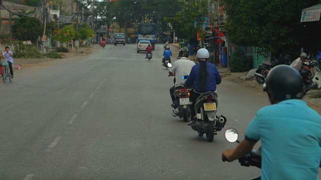 Men On Motorcycles Driving On The Road Next To The Machines On A Cloudy Day