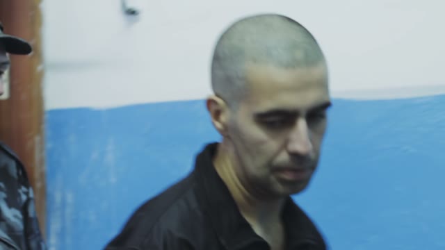 The Police And The Offender Pass Through The Corridor