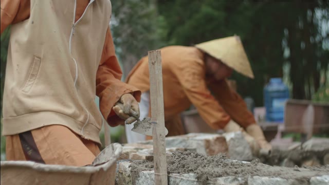Men Are Building A House Out Of Stone