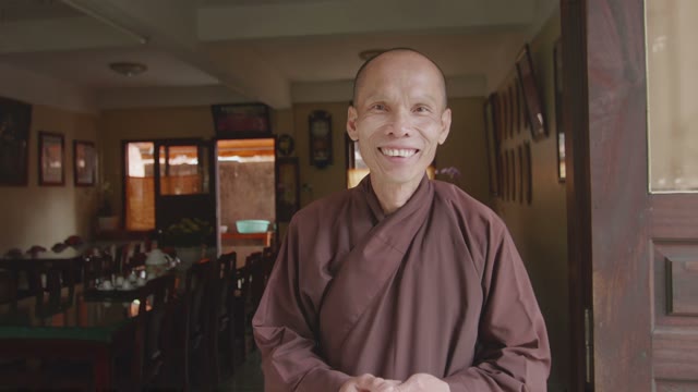 Smiling Monk In A Brown Robe Close-up