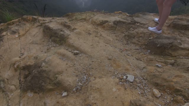 Woman Standing At The Cliff Of Mount