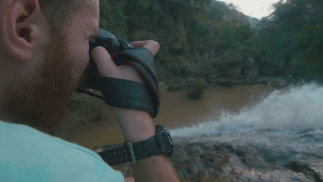 Man Takes A Picture Of A Waterfall Close-up