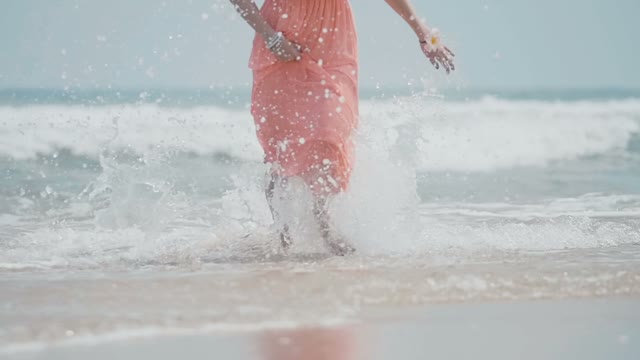 Attractive Girl With Slim Legs Running Along The Beach