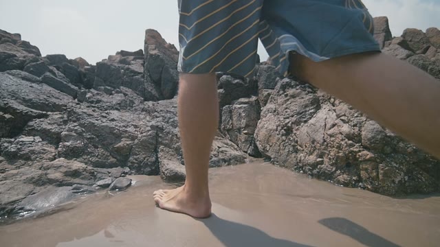The Young Guy Climbs Onto The Rock