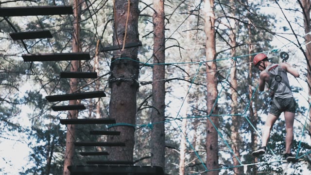 Man Scrambles Over An Obstacle